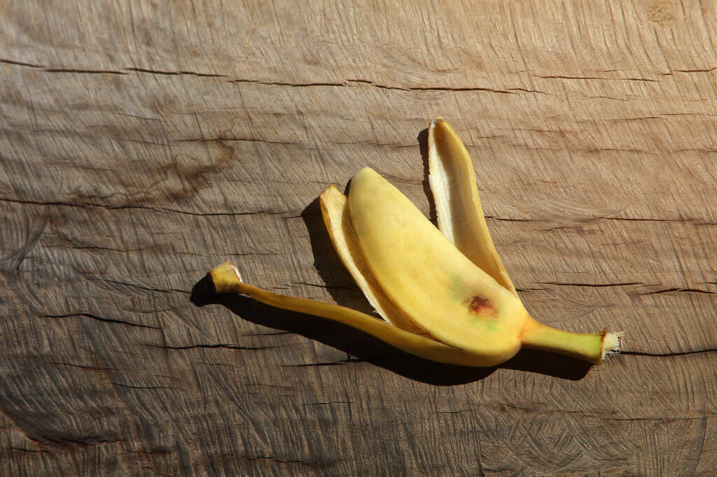 Banana peel on wood background (with clipping path). this color is retro  style